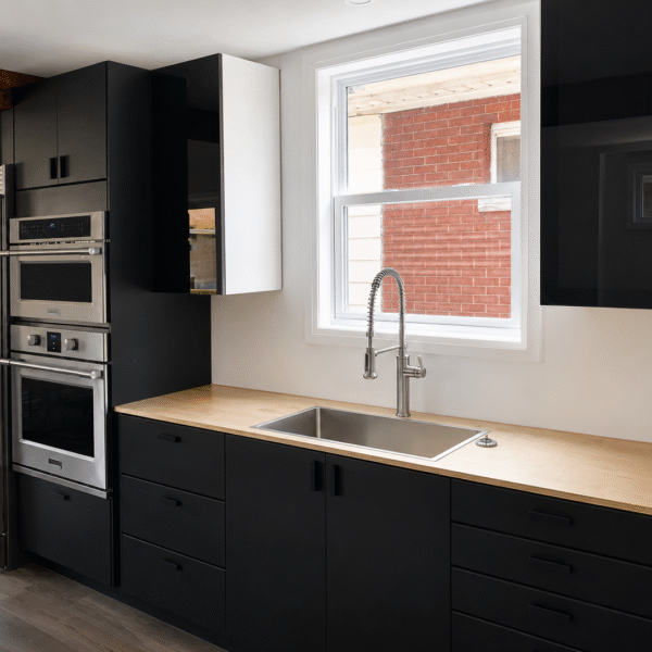 Bold Matte Black Kitchen with Warm Wood Beams